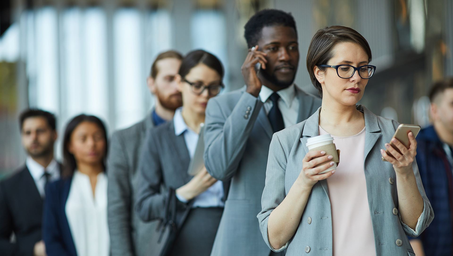 Business people standing in line waiting