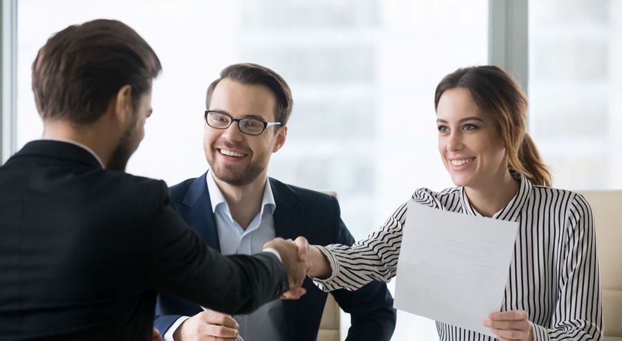 Business people looking at an application and shaking hands